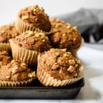 Hearty and satisfying whole wheat muffins filled with bananas and tons of cinnamon! Find the recipe at runlifteatrepeat.com.