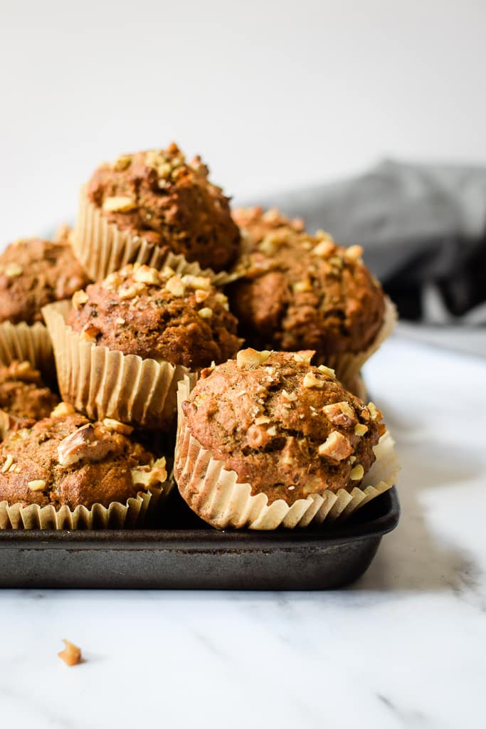 Hearty and satisfying whole wheat muffins filled with bananas and tons of cinnamon! Find the recipe at runlifteatrepeat.com.