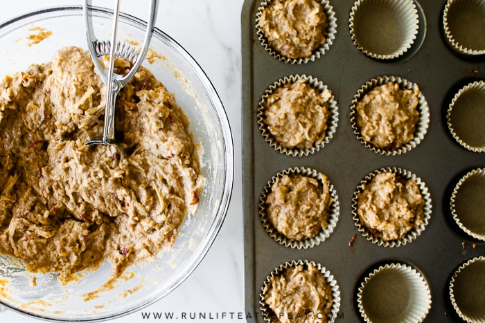 Healthy whole wheat muffins filled with shredded apples, tons of cinnamon spice and zero refined sugar! Find the recipe at runlifteatrepeat.com. #wholewheatmuffins #muffins #breakfast #apple #cinnamon #dairyfree