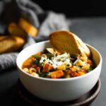 This minestrone soup is a favorite for obvious reasons. It's hearty, filled with tons of vegetables, and packed with flavor. It's the soup recipe that you'll make again and again! #soup #dinner #recipe #easy #healthy