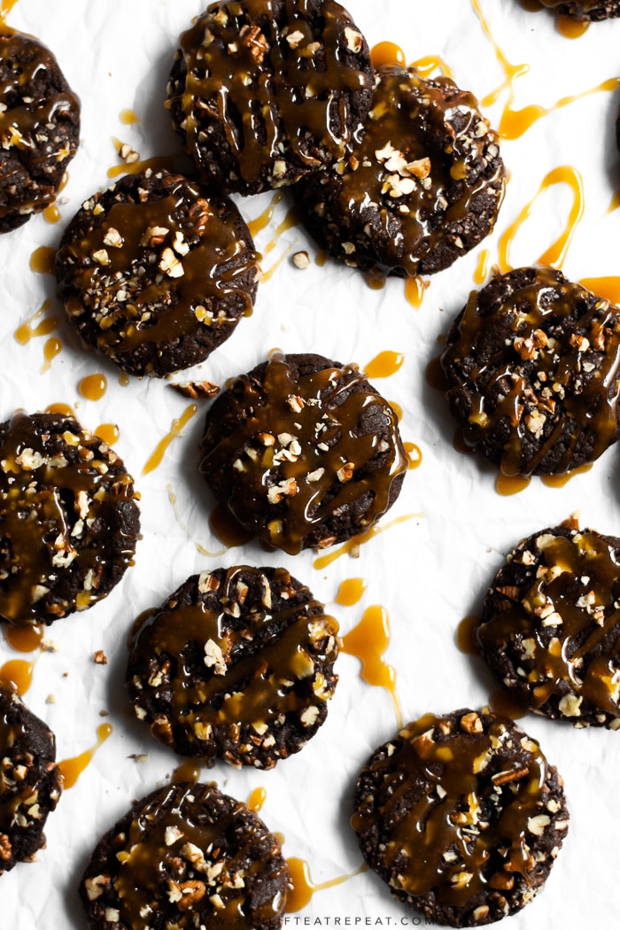 Fudgy brownie-like cookies rolled in pecans and topped with a drizzle of homemade caramel.Â #cookies #chocolate #pecans #brownie #christmas