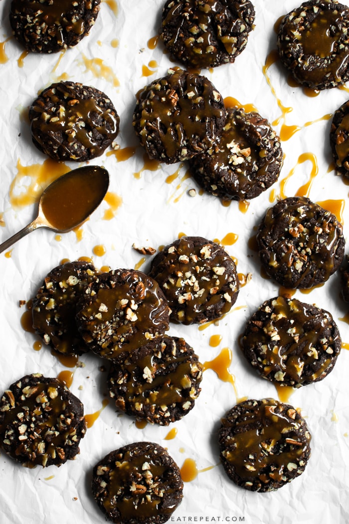 Fudgy brownie-like cookies rolled in pecans and topped with a drizzle of homemade caramel.Â #cookies #chocolate #pecans #brownie #christmas