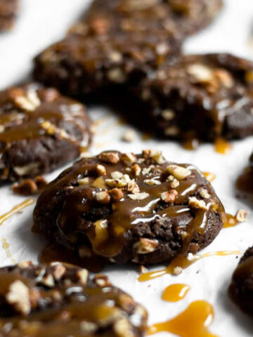 Fudgy brownie-like cookies rolled in pecans and topped with a drizzle of homemade caramel. 