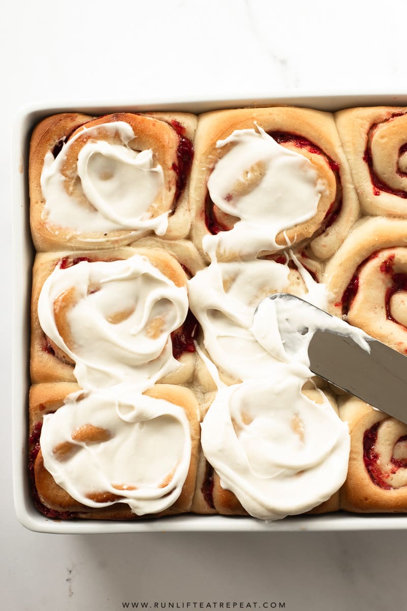 These soft & fluffy homemade sweet rolls are filled with strawberries and topped with a thick layer of cream cheese icing. Breakfast has never tasted so good! #breakfast #cinnamonrolls #sweetrolls