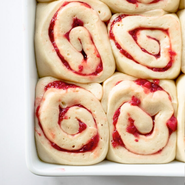 These soft & fluffy homemade sweet rolls are filled with strawberries and topped with a thick layer of cream cheese icing. Breakfast has never tasted so good!