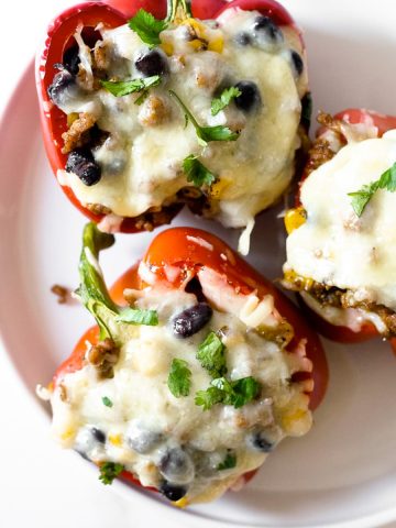 If you’re searching for an easy weeknight dinner recipe that satisfies and one that the family will love, look no further. These Mexican Stuffed Peppers are packed with flavor from the spices and come together in no time!