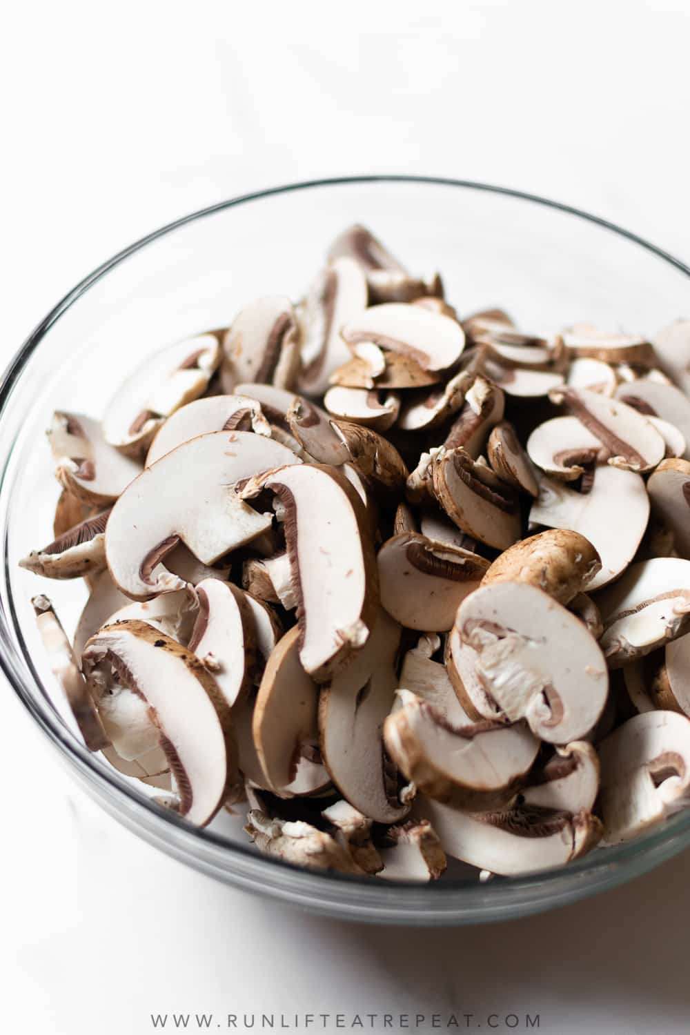 sliced mushrooms in a bowl on table