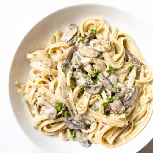 Look no further for your next pasta dish, this easy creamy mushroom pasta recipe is guaranteed to impress. The creamy mushroom sauce is undeniably delicious– the mushrooms are sautéed in butter with garlic and spices, paired with white wine (or chicken broth), heavy cream and reserved pasta water with a touch of fresh lemon juice to finish it off. It's a flavorful pasta dish that uses minimal basic ingredients to create a recipe easy enough for a weeknight dinner and fancy enough for a special occasion.