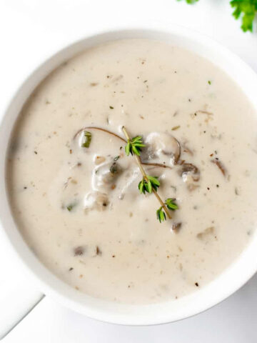 This cream of mushroom soup recipe is easy, homemade, and satisfying. Just a few ingredients paired with tons of mushrooms and this soup will have your mouth watering as it cooks.