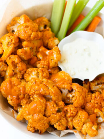 This buffalo cauliflower can be baked or made in the air fryer. This recipe is easy to make and delivers all of the same flavor of buffalo wings but in a lighter way! This buffalo cauliflower recipe will be the star of all other appetizers.