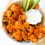 This buffalo cauliflower can be baked or made in the air fryer. This recipe is easy to make and delivers all of the same flavor of buffalo wings but in a lighter way! This buffalo cauliflower recipe will be the star of all other appetizers.
