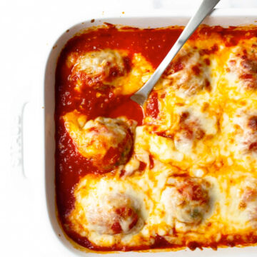 This oven baked meatballs recipe is a family favorite and an easy weeknight dinner. The meatballs are made with ground turkey or beef, a combination of spices and a few other basic ingredients. The meatballs are baked in the oven with tomato sauce until tender and topped with shredded mozzarella cheese.
