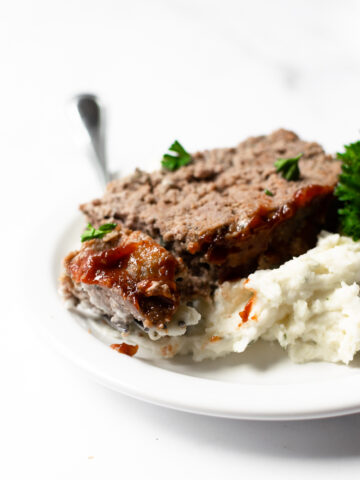 I present to you the best meatloaf recipe— it's tender, juicy, loaded with flavor and topped with unique but delicious glaze. This meatloaf recipe is easy to make and ready in less than an hour! It's