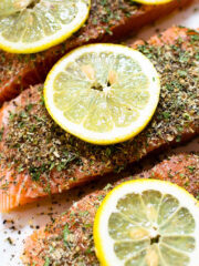 This easy baked herb crusted salmon is guaranteed to impress. It's smothered in an herb mixture and is ready in under 35 minutes!