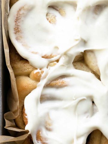 These homemade cinnamon rolls are soft and fluffy, filled with the most delicious cinnamon sugar swirl, have warm and gooey centers, slightly golden brown edges, and smothered in a generous amount of cream cheese frosting. Nothing beats this classic recipe!