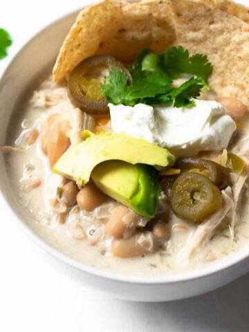 This slow cooker white chicken chili is a life saver during busy weeknights. It's an incredibly flavorful, comforting and easy recipe to make. It will guaranteed be a huge hit, even for those that typically don't like chili!
