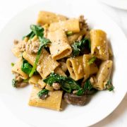 This creamy Italian sausage pasta is coated in a light, garlic, cheesy cream sauce and filled with Italian sausage, mushrooms and spinach. It's the one pan recipe that will be your new favorite weeknight dinner.