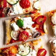 This zucchini & tomato herbed ricotta flatbread pizza uses my favorite flatbread dough recipe. It's topped with herbed garlic ricotta cheese, zucchini, tomatoes, and a little fresh basil to finish it off. It's a dinner recipe that the entire family loves!