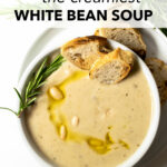 Creamy White Bean Soup is a delicious dish made with potatoes, beans, onions, garlic, broth, spices, and milk. This comforting soup is the perfect weeknight dinner and is ready to eat in just 25 minutes. It's packed with flavor and has a creamy texture that everyone in your family will love.