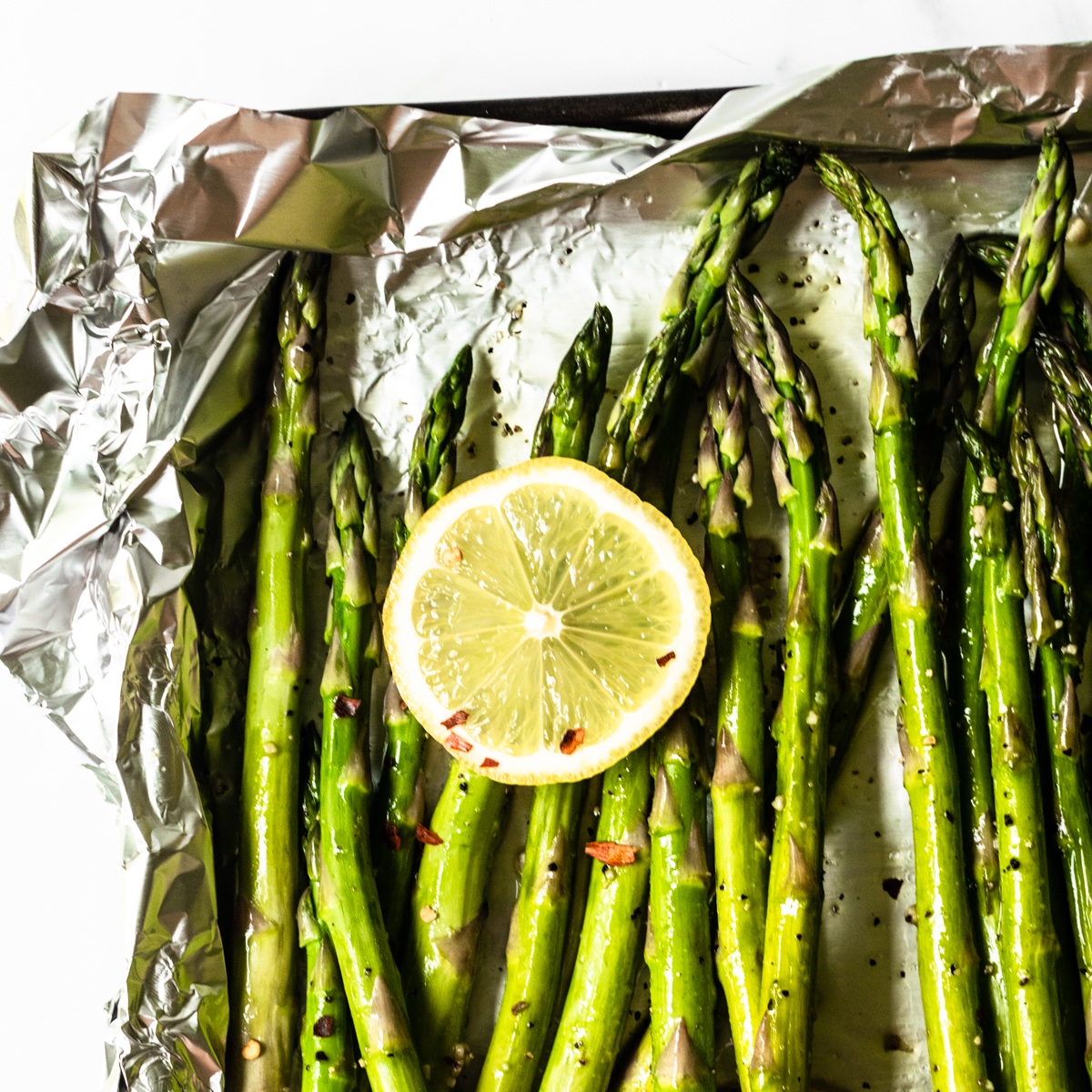 This roasted asparagus recipe is seasoned with olive oil, fresh garlic, salt, and pepper, and finished with freshly squeezed lemon juice. It's a simple side dish that everyone will love and on the table in just 20 minutes!