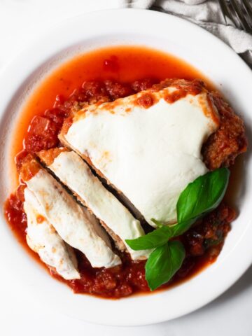 Learn how to make chicken parmesan at home in just 35 minutes! It's made with basic ingredients and smothered in flavorful marinara sauce, topped with fresh mozzarella cheese. It's the easiest chicken parmesan recipe that you'll ever make!