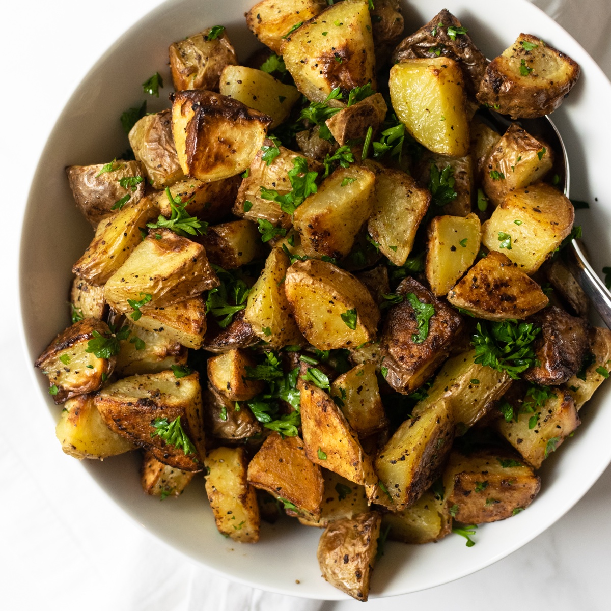 These oven roasted potatoes are tender and buttery on the inside and perfectly crispy on the outside. Tossed together with olive oil, whole grain mustard, garlic, salt, and pepper and baked at a high temperature— these potatoes will be the star of show!