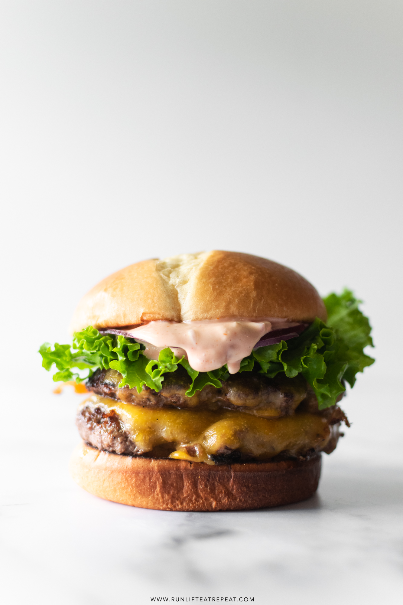 The best smash burger recipe— zero exaggeration! These burgers are incredibly juicy, perfectly crispy, smothered in cheese, and topped with a hefty amount of secret sauce. Serve between a toasted brioche bun and this is truly the ultimate smash burger recipe.