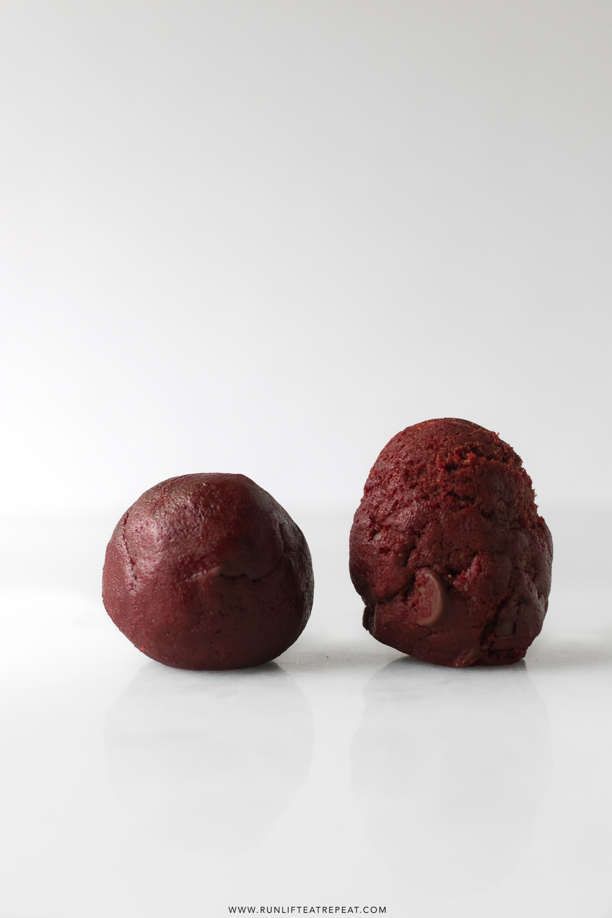 raw red velvet chocolate chip cookie dough balls side by side