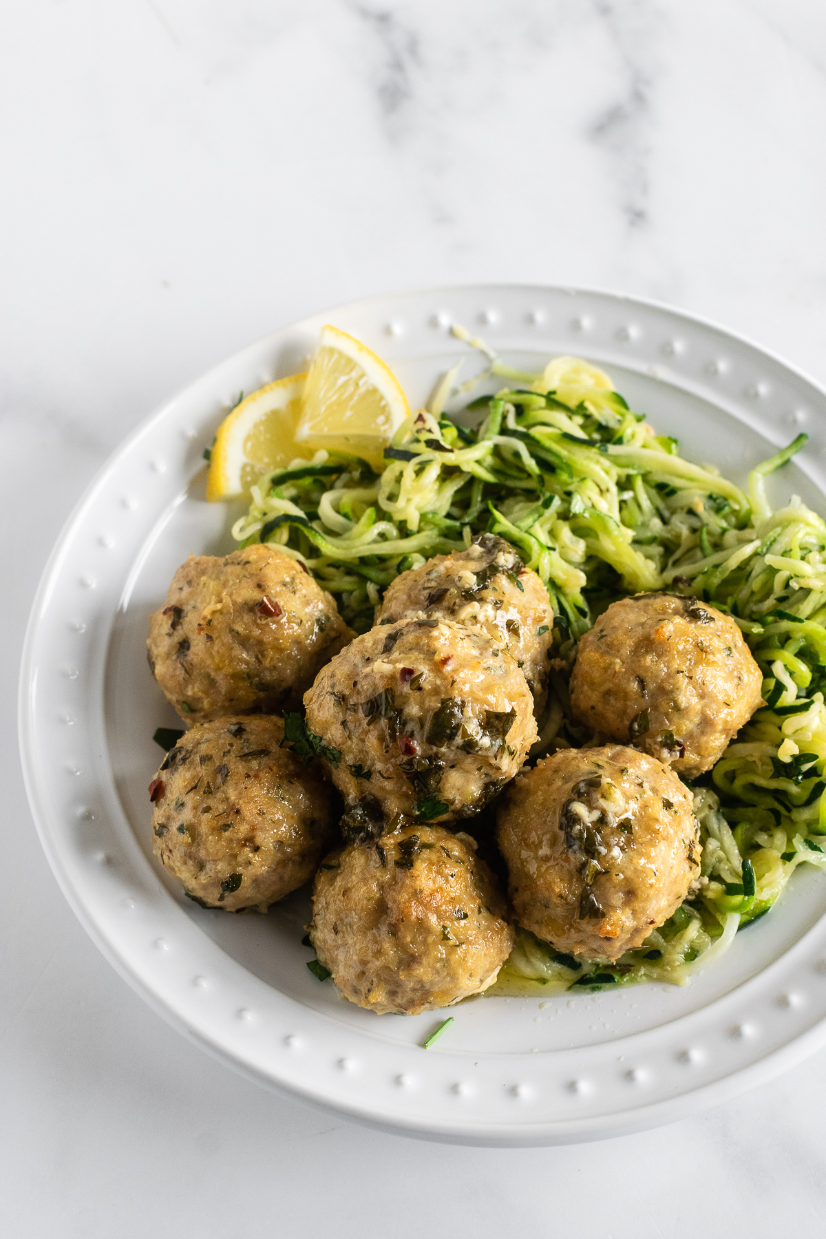 chicken meatballs on a plate with zucchini noodles