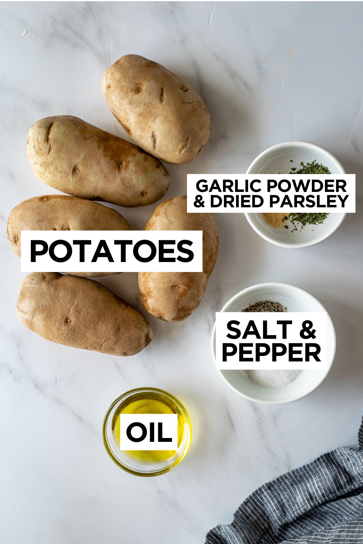 ingredients for baked french fries such as potatoes, garlic powder, dried parsley, salt, pepper and olive oil.
