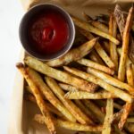 french fries on a baking sheet with a napkin.