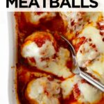 baked chicken parmesan meatballs in a white baking dish with spoon.