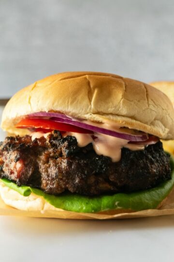 bacon cheeseburgers topped with secret sauce, melted cheese, lettuce, tomato and red onion.
