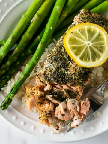 If you're looking for a quick and easy dinner that delivers, try this baked herb crusted salmon. Brushed with butter, topped with a flavorful spice rub, and finished with lemon slices. Bonus: this baked salmon is done in under 30 minutes!
