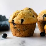 bluberry muffins on a white table.