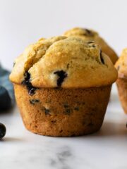 bluberry muffins on a white table.