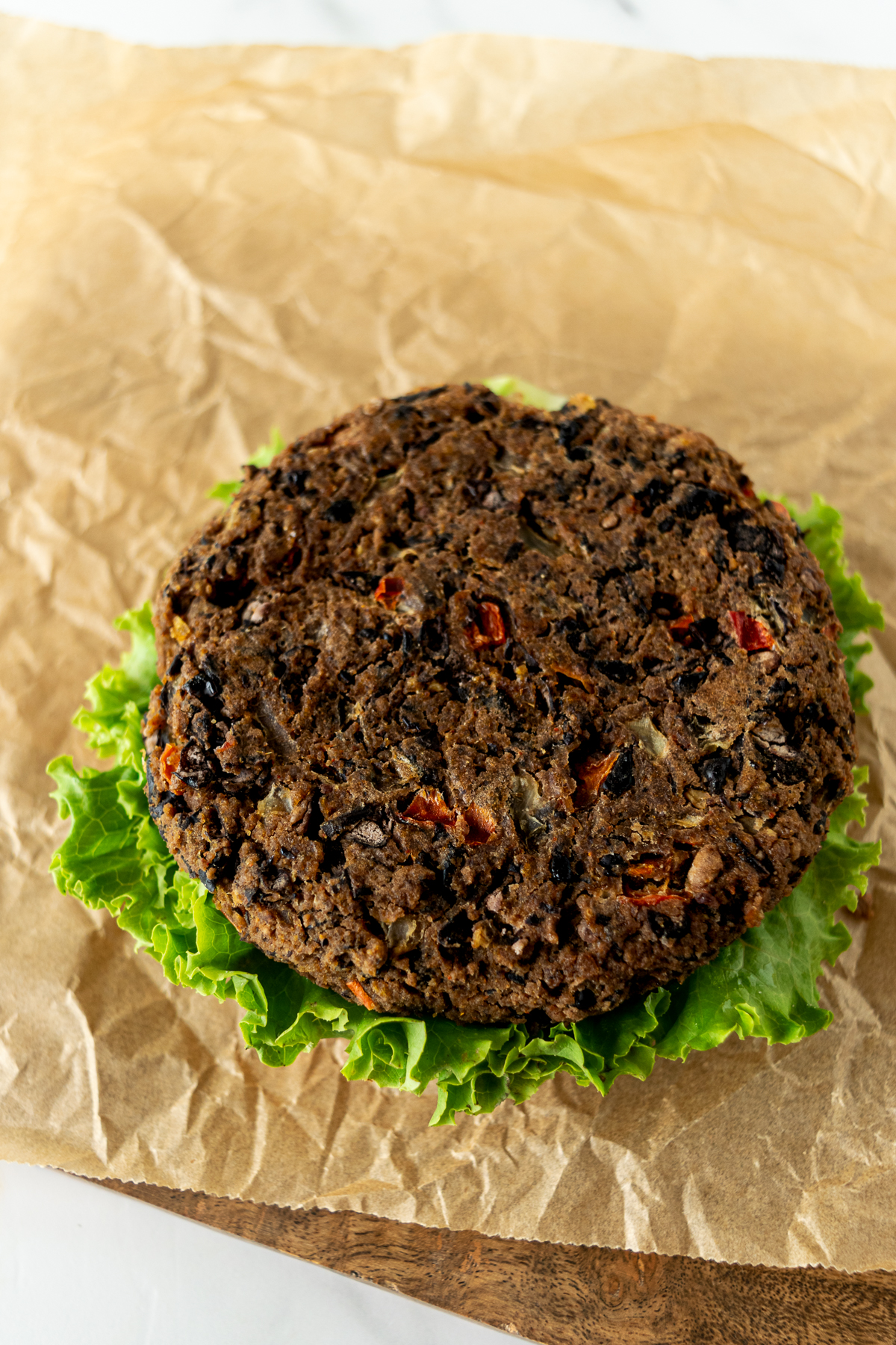 black bean burger sitting on lettuce.