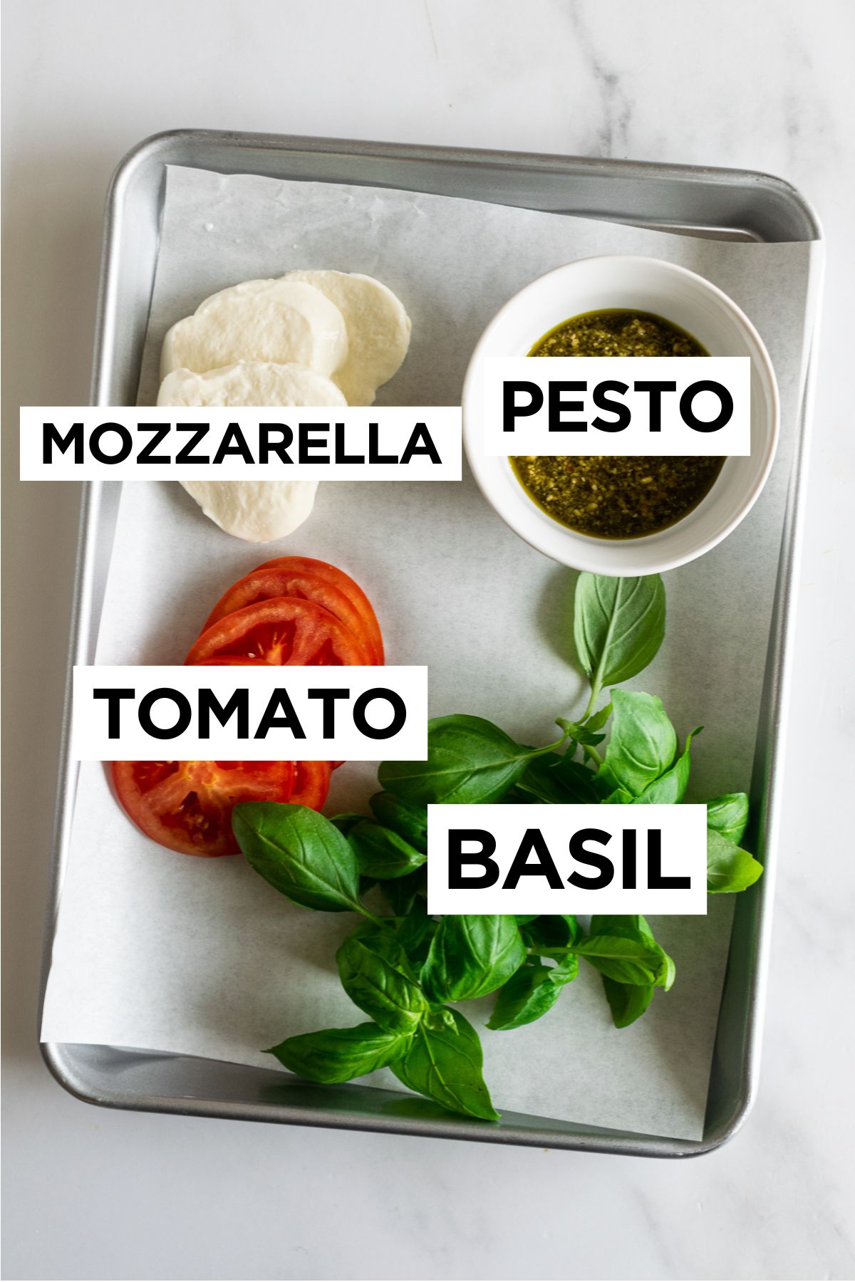 caprese burger toppings such as basil, tomatoes, mozzarella and pesto.