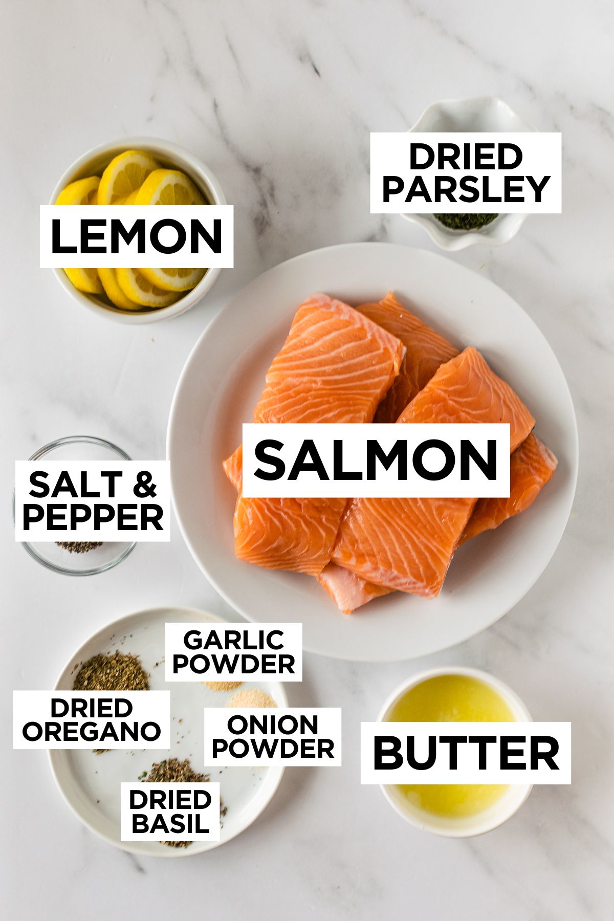 baked herb crusted salmon ingredients in bowls such as salmon, lemon, spices, and melted butter.