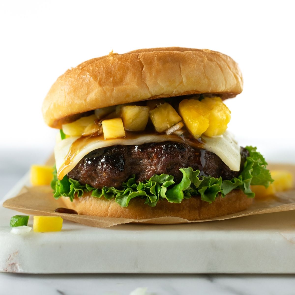 teriyaki burgers with melted cheese, lettuce, and pineapple salsa.