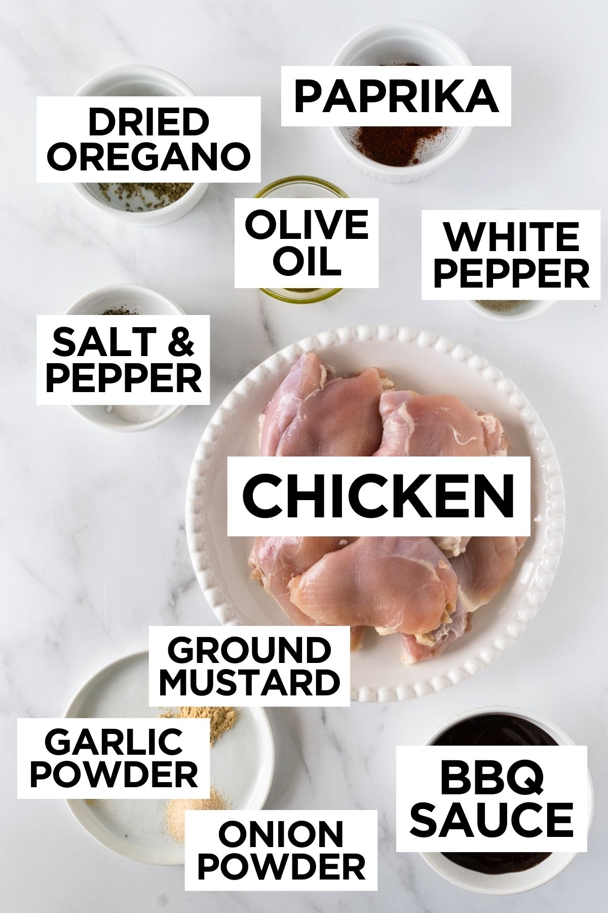 ingredients for bbq chicken in bowls on a white table.