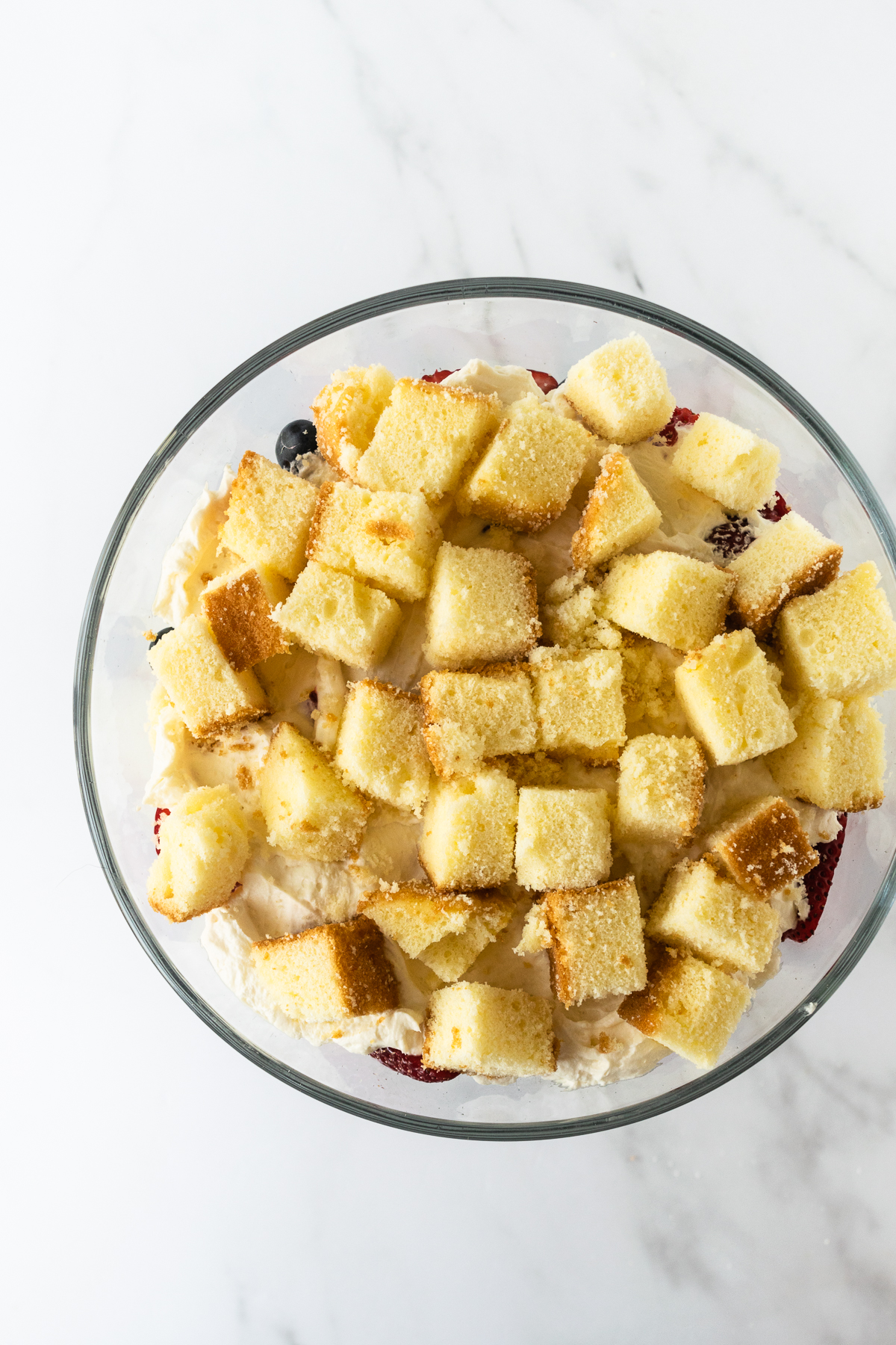 overhead view of trifle with pound cake layer in trifle bowl.