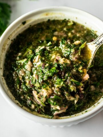 The only chimichurri recipe you'll ever need! Making homemade chimichurri sauce is easy and comes together in just 5 minutes in a food processor. Incredibly flavorful– use it as a marinade, top on steak, chicken or almost any dish... or simply enjoy by the spoonful!
