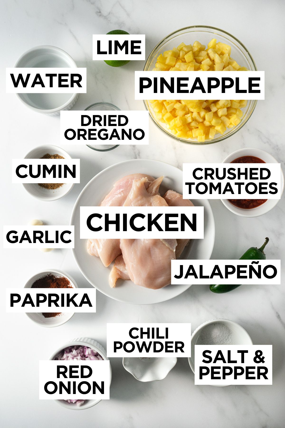 ingredients for hawaiian chicken tacos in bowls on a white table.