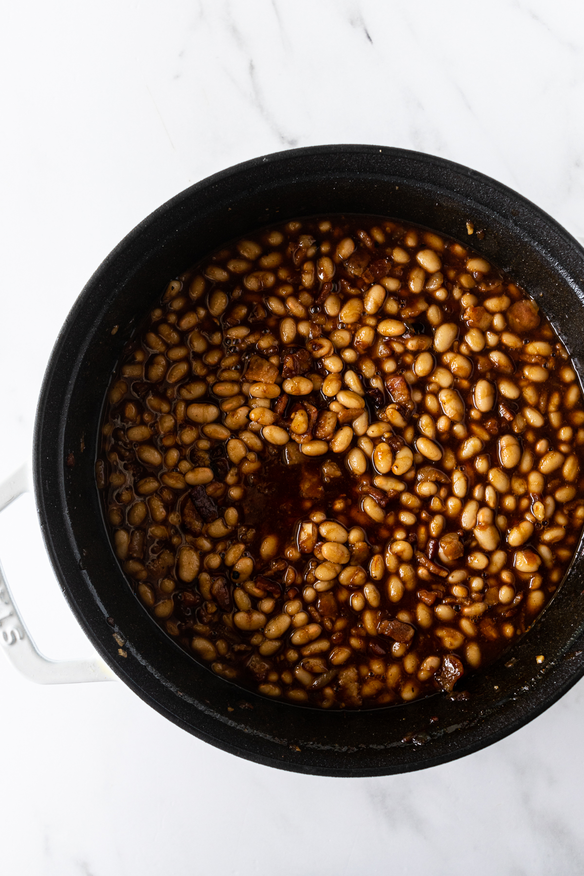 baked beans in a black pot.