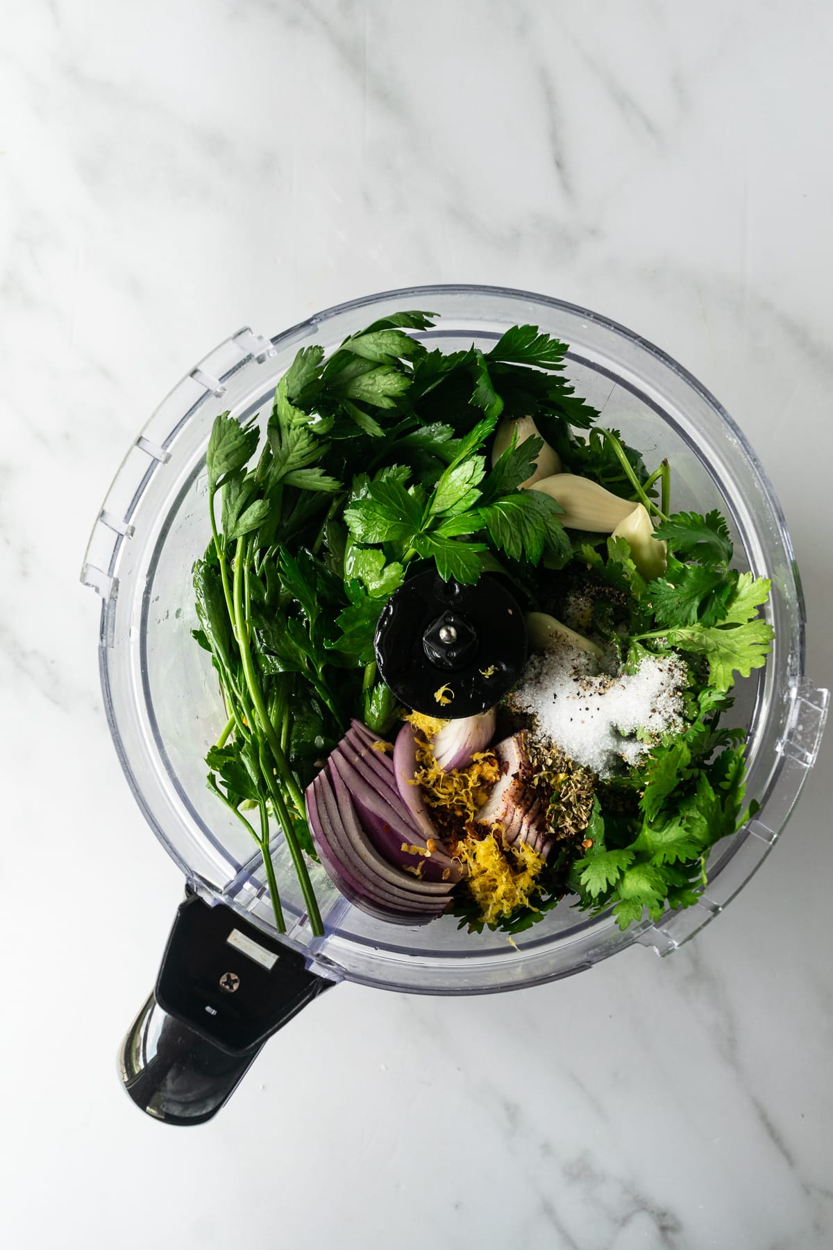 ingredients for chimichurri in a food processor.