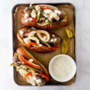 sheet pan sausage and peppers sandwiches on a sheet pan.