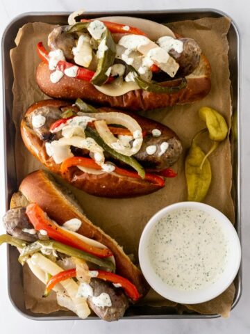 You'll love this easy sheet pan sausage and peppers recipe– juicy Italian sausage perfectly cooked every time with bell peppers and onions. Make it the ultimate sausage and peppers sandwich by serving inside a toasted brioche roll with melty provolone cheese and topped with a garlic aioli. It's guaranteed to be a hit with family! Bonus: it only takes 30 minutes start to finish!