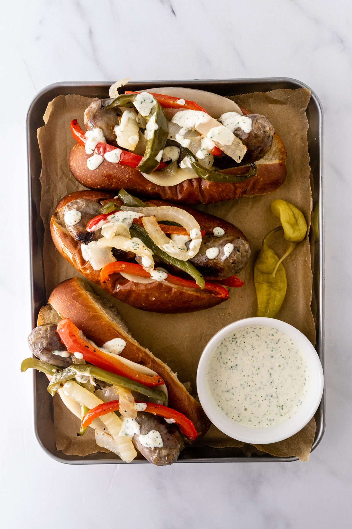 sheet pan sausage and peppers sandwiches on a sheet pan.