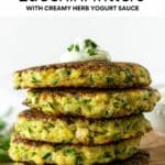 stacked zucchini fritters topped with yogurt sauce with text overlay.